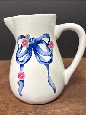 White Ceramic Pitcher with Blue Ribbon and Pink Floral Accents